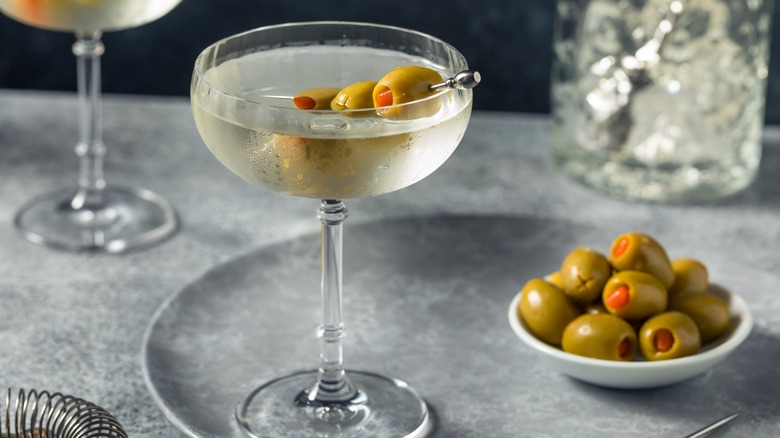 martini with bowl of olives