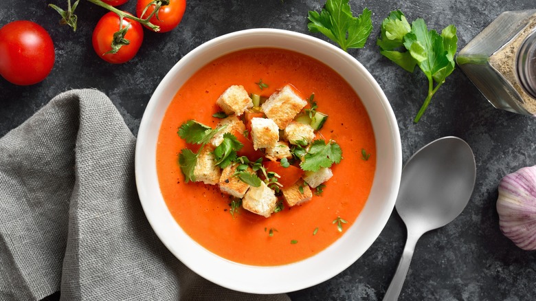 Bowl of tomato soup loaded with croutons