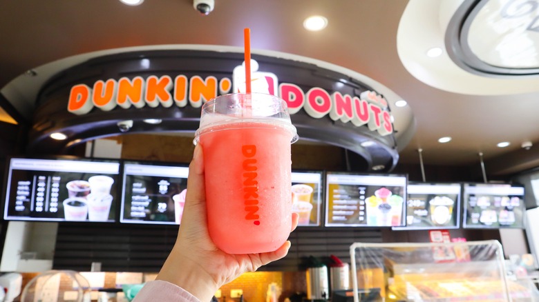 person holding Dunkin Coolatta