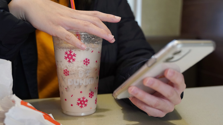 Person drinking Dunkin' iced latte