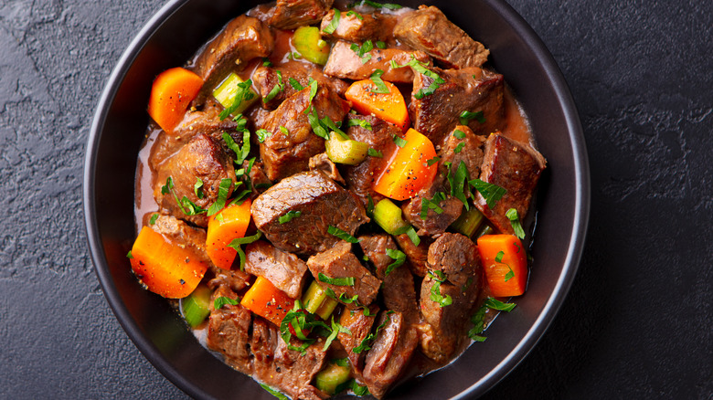 bowl of braised meat with roasted vegetables