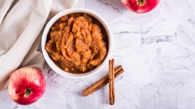 Brown applesauce with cinnamon sticks