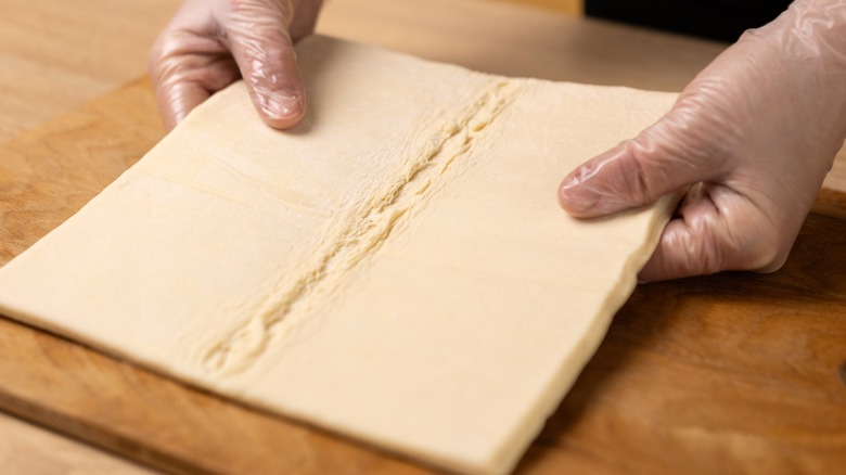 chef holding pastry dough