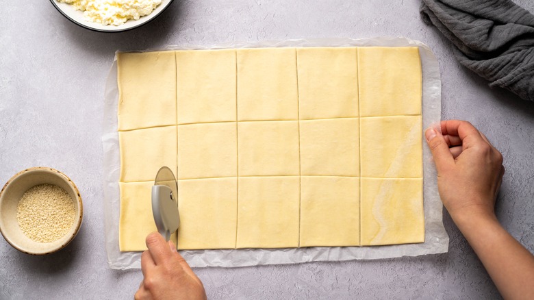 cutting raw pastry dough