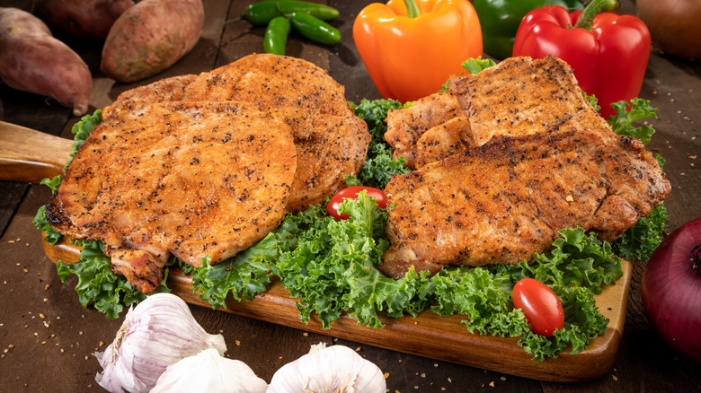 tray of butterflied pork chops with seasonings