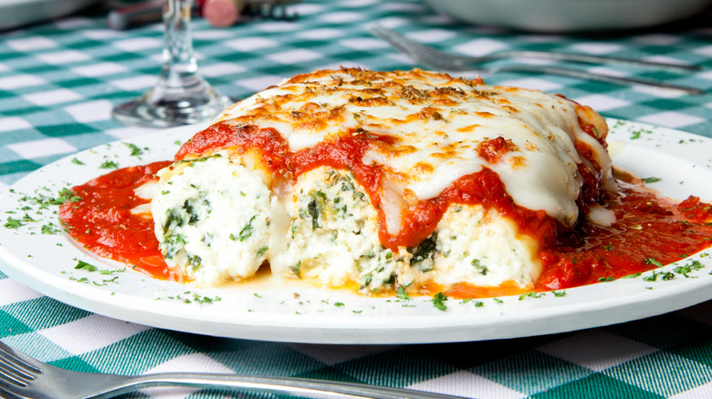 Dish of manicotti on checkered tablecloth