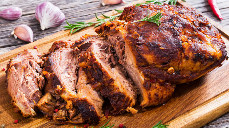 barbecue pork shoulder sliced on a cutting board