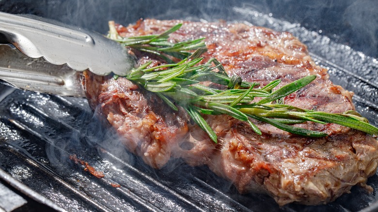 rosemary and steak on grill