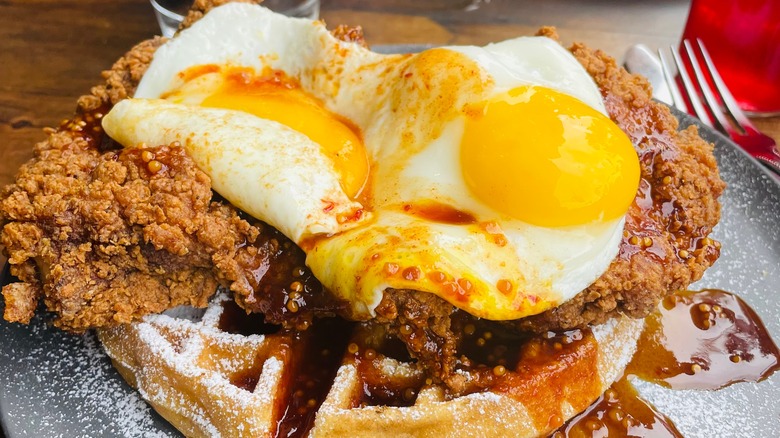 chicken and waffle with runny fried egg on top