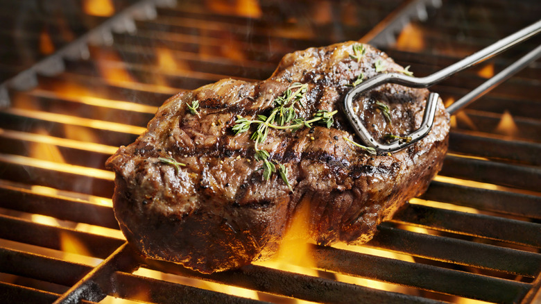 Juicy steak cooked on a flame grill