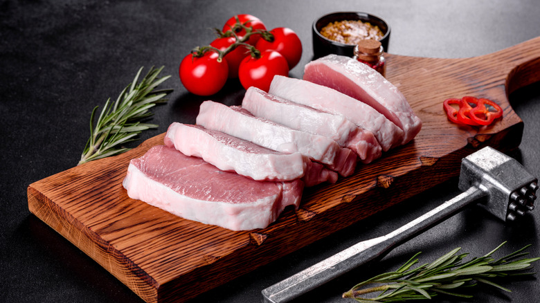 sliced pork tenderloin on cutting board