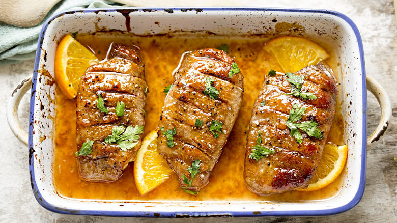 Duck breasts in a dish with oil