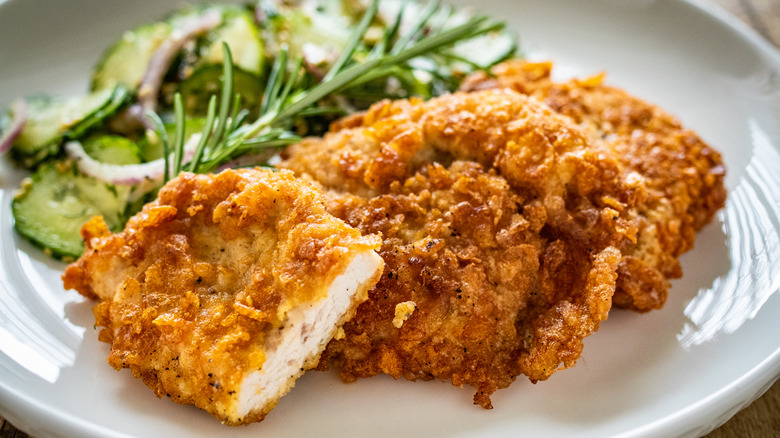 plate of breaded chicken with salad