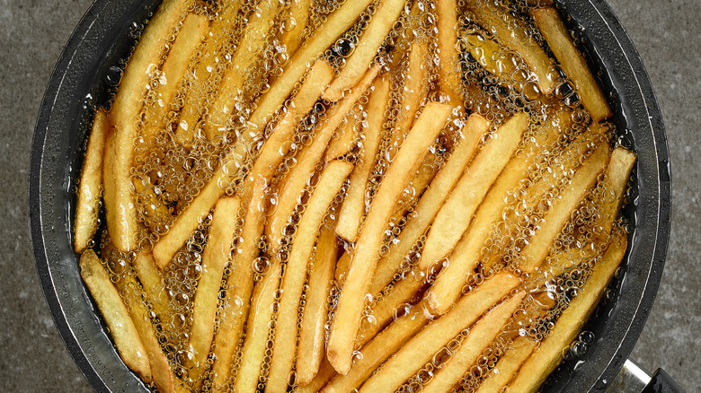 French fries frying in pan