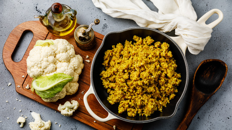 cooked cauliflower rice and fresh cauliflower