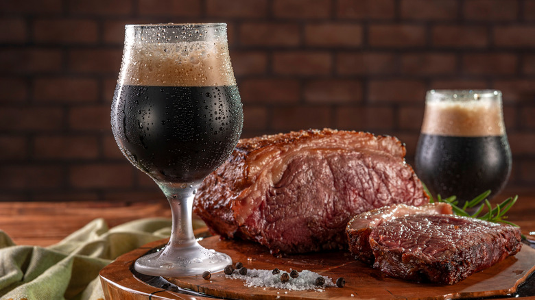 two glasses of stout and a grilled roast beef