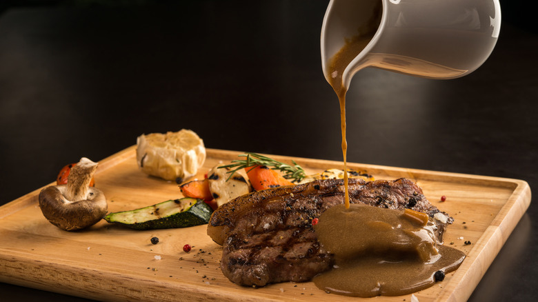 Gravy being poured on meat