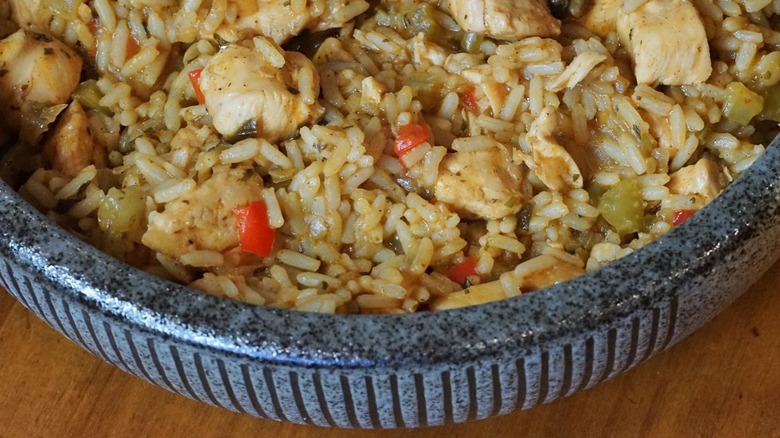 a close up of a bowl of prepared cajun chicken rice mix