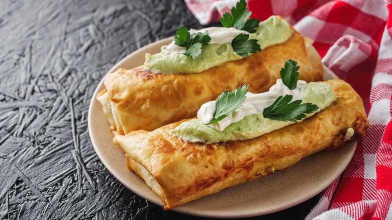 Deep-fried chimichangas on plate