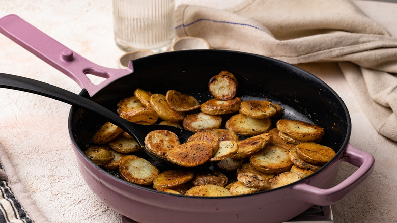 potato discs frying in a skillet