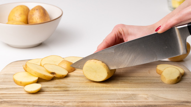 potatoes sliced on a cutting board