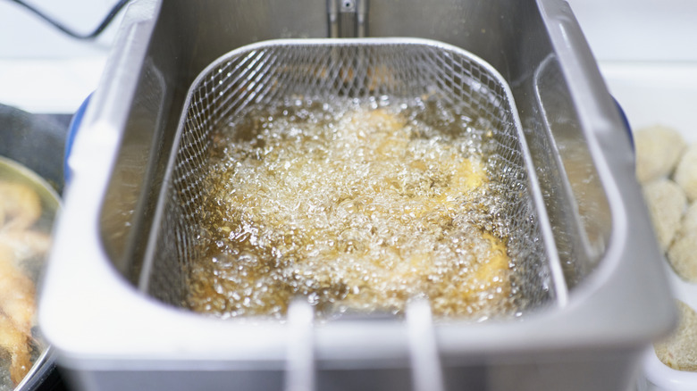 frying calamari in deep fryer basket