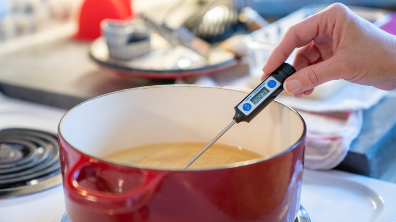 dutch oven with oil and thermometer