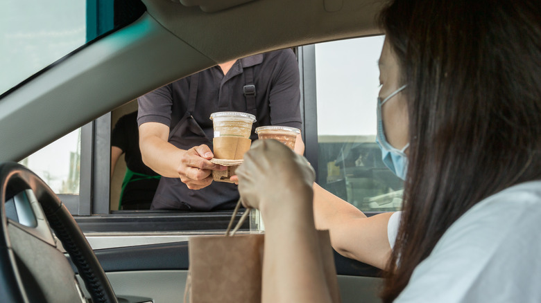 person getting food from drive-thru