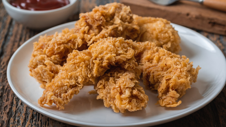 Chicken strips on white plate