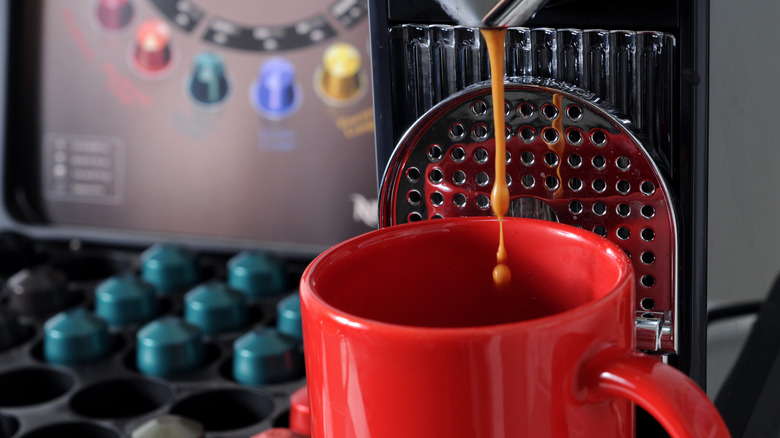 A Nespresso machine brewing a cup.