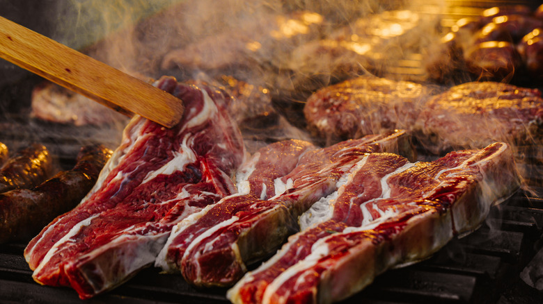 smoked ribeye steak in tongs