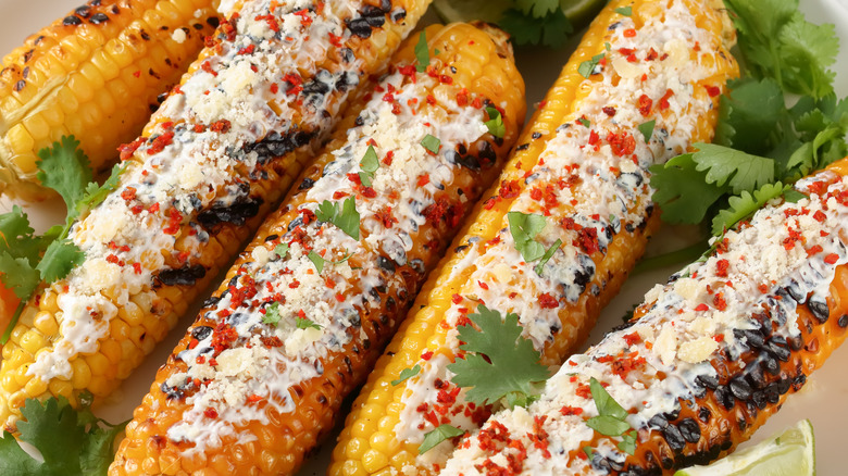 mayonnaise and seasoning spread over roasted corn