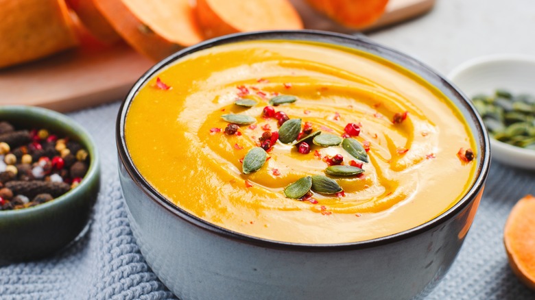 A bowl of sweet potato soup with nuts as topping