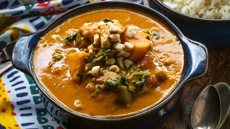 A close up of African peanut stew in a casserole dish