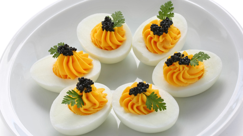 Several deviled eggs with caviar