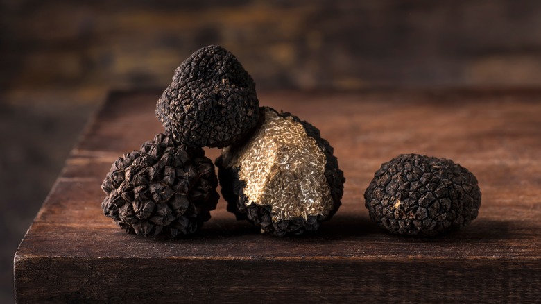 black truffles on wooden board