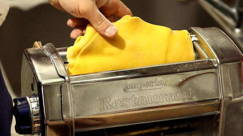 rolling pasta in pasta machine