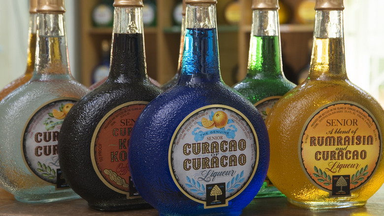 A bottle of blue Curaçao liqueur with other liquers