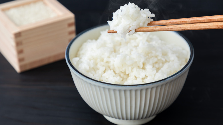 chopsticks holding up white rice