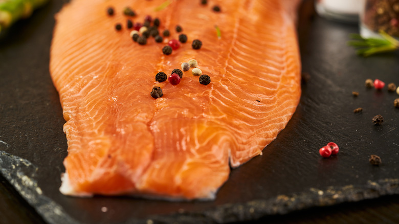 Smoked salmon uncut with peppercorns on top 