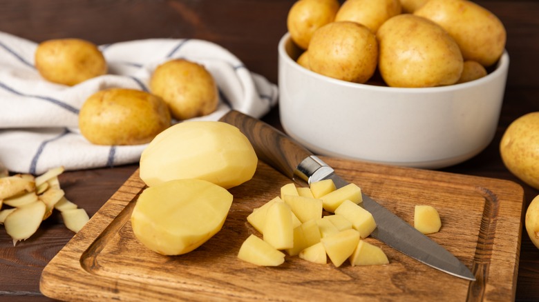 chopping potatoes on cutting board