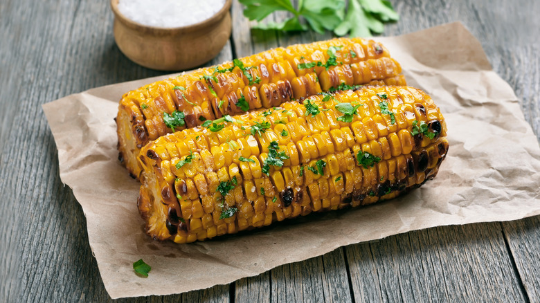 Grilled corn on the cob with herbs