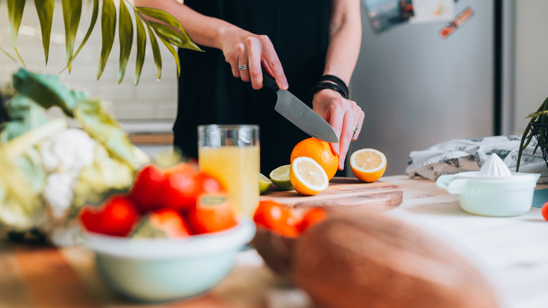 woman cutting fresh fruit