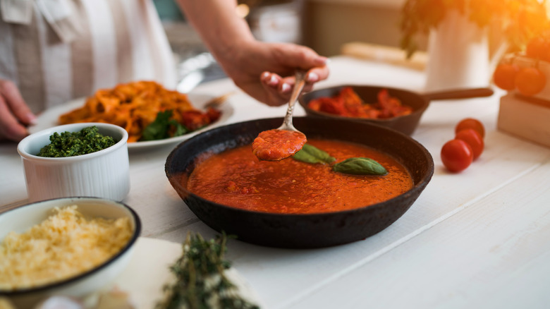 woman making tomato sauce