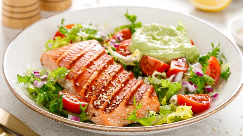 Grilled salmon salad on white plate