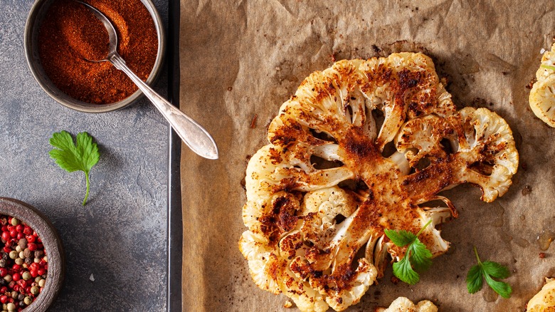 roasted cauliflower steak on a parchment lined baking sheet