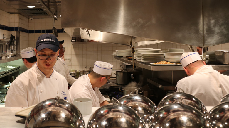 cooks working inside Le Bernardin restaurant