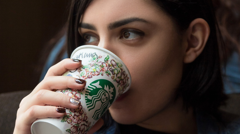 woman drinking starbucks hot drink