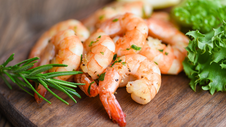 Cooked shrimp on a wooden platter