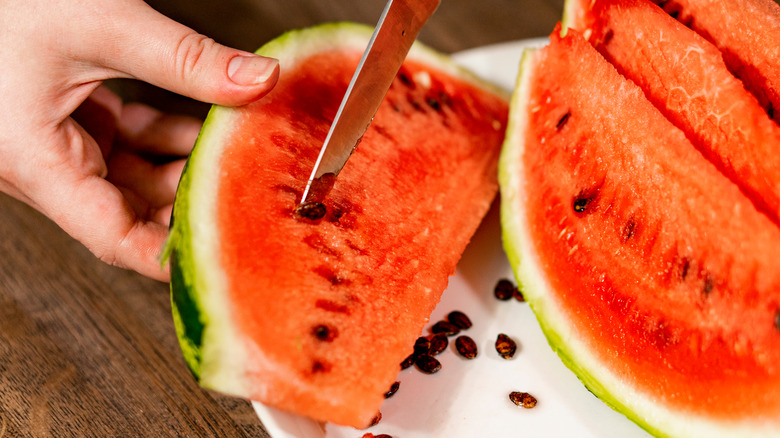 removing seeds from a watermelon with a knife